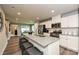 Gourmet kitchen featuring a granite island, stainless steel appliances, and seamless flow to dining area at 124 Kristin View Ln # Townhome A, Troutman, NC 28166