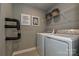 Laundry room with a washer, a dryer, wall art, and an overhead storage shelf at 124 Kristin View Ln # Townhome A, Troutman, NC 28166