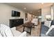 Open-concept living room featuring modern furnishings and flows into the kitchen and dining area at 124 Kristin View Ln # Townhome A, Troutman, NC 28166
