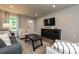 Cozy living room with a flat-screen TV, stylish decor, and ample natural light at 124 Kristin View Ln # Townhome A, Troutman, NC 28166