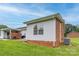 Exterior view of the brick and vinyl siding home, with grassy yard and blue skies at 130 24Th Nw St, Hickory, NC 28601