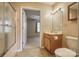 Clean bathroom with single vanity, toilet, shower, and view into bedroom at 130 24Th Nw St, Hickory, NC 28601