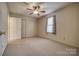 Bright bedroom with a ceiling fan, natural light, double closets, and neutral carpet at 130 24Th Nw St, Hickory, NC 28601