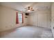 Bedroom with carpet, ceiling fan, window with curtains, and double door closets at 130 24Th Nw St, Hickory, NC 28601