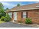 Charming brick home exterior with neat landscaping, shutters, and inviting front door at 130 24Th Nw St, Hickory, NC 28601
