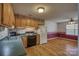 Classic kitchen with wood cabinets, black appliances, and adjacent dining area at 130 24Th Nw St, Hickory, NC 28601