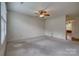 Bright living room featuring neutral carpet, ceiling fan, and ample natural light at 130 24Th Nw St, Hickory, NC 28601