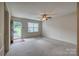 Bright living room featuring neutral carpet, ceiling fan, and ample natural light at 130 24Th Nw St, Hickory, NC 28601