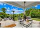 Inviting covered back patio with comfortable seating, fire pit and lush landscaping at 138 Chase Water Dr, Mooresville, NC 28117