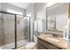 Well-appointed bathroom featuring a glass enclosed shower, granite countertop, and a decorative mirror over the vanity at 138 Chase Water Dr, Mooresville, NC 28117