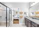 Modern bathroom featuring a glass-enclosed shower and a vanity with granite countertop and views to the bedroom at 138 Chase Water Dr, Mooresville, NC 28117