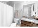 Guest bathroom with granite vanity, white toilet and shower with curtain at 138 Chase Water Dr, Mooresville, NC 28117