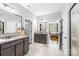 Bright bathroom with dual sinks, granite countertops, and tiled floor adjacent to the main bedroom at 138 Chase Water Dr, Mooresville, NC 28117