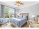 Cozy bedroom with a large window, ceiling fan, chair and desk, offering a comfortable and bright space at 138 Chase Water Dr, Mooresville, NC 28117