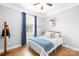 Comfortable bedroom with a ceiling fan, window, and bed with nautical decor, creating a relaxing atmosphere at 138 Chase Water Dr, Mooresville, NC 28117