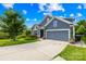 Lovely one story home with a well-manicured lawn, mature tree and a two car garage with a blue colored exterior at 138 Chase Water Dr, Mooresville, NC 28117