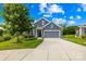 Charming single-Gathering home with a well-manicured lawn, mature tree and a two car garage, offering great curb appeal at 138 Chase Water Dr, Mooresville, NC 28117