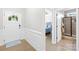 Inviting entryway with hardwood floors, decorative wainscoting, a front door with glass, and views to the bedroom at 138 Chase Water Dr, Mooresville, NC 28117
