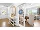 Stylish hallway with hardwood floors, white wainscoting, leading to an office space with a glass panel door at 138 Chase Water Dr, Mooresville, NC 28117