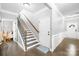 Hallway with hardwood floors, staircase, decorative wainscoting, and white doors leading to additional rooms at 138 Chase Water Dr, Mooresville, NC 28117
