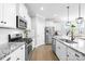 Well-equipped kitchen with granite counters, stainless steel appliances, white cabinets, and subway tile backsplash at 138 Chase Water Dr, Mooresville, NC 28117