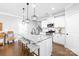 Modern eat-in kitchen boasts white cabinets, stainless appliances, granite counters and pendant lighting at 138 Chase Water Dr, Mooresville, NC 28117