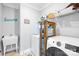 Convenient laundry room with utility sink, washer, dryer and shelving for optimal storage at 138 Chase Water Dr, Mooresville, NC 28117