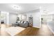 Open-concept living room with lots of natural light, wood floors and neutral wall paint at 138 Chase Water Dr, Mooresville, NC 28117