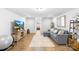 Cozy living room with wood floors, comfortable seating, and a TV for entertainment at 138 Chase Water Dr, Mooresville, NC 28117