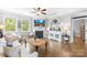 Inviting living room with hardwood floors, fireplace, and elegant built-in shelves and cabinets at 138 Chase Water Dr, Mooresville, NC 28117