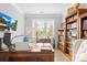 Bright home office featuring a large window, built-in bookshelves, and a spacious desk for a productive workspace at 138 Chase Water Dr, Mooresville, NC 28117