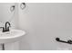 Elegant powder room featuring a pedestal sink with modern fixtures and clean design at 1420 Tyler St, Kannapolis, NC 28083