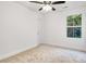 Cozy bedroom with neutral carpet, a ceiling fan, and a bright window at 1420 Tyler St, Kannapolis, NC 28083