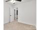 Bedroom featuring neutral carpet, ceiling fan, and an adjoining bathroom at 1420 Tyler St, Kannapolis, NC 28083