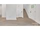 Bright hallway with wood-look flooring, white walls, and a staircase to the upper level at 1420 Tyler St, Kannapolis, NC 28083