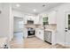 Modern kitchen boasts stainless steel appliances, white cabinetry, and light countertops at 1420 Tyler St, Kannapolis, NC 28083