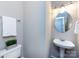 Updated half bathroom features a pedestal sink, toilet, decorative mirror and towel bar at 1423 Piper Ct, Concord, NC 28025