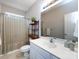 Bright bathroom features a white vanity, framed mirror and shower with decorative shelves at 1423 Piper Ct, Concord, NC 28025