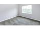 Bright, airy bedroom with large window and carpeted floors at 1423 Piper Ct, Concord, NC 28025