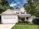 Charming two-story home with manicured front lawn, attached two-car garage, and inviting front porch at 1423 Piper Ct, Concord, NC 28025