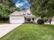 Beautiful two-story home boasting lush landscaping, a spacious front yard, and an attached garage at 1423 Piper Ct, Concord, NC 28025