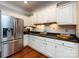 Bright kitchen with white cabinets, stainless steel appliances and hardwood floors at 1423 Piper Ct, Concord, NC 28025