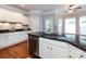 Well-lit kitchen with stainless steel dishwasher, granite countertops, and white cabinets at 1423 Piper Ct, Concord, NC 28025