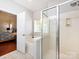 View of shower and bath in main bathroom with tile flooring and a window for light at 1423 Piper Ct, Concord, NC 28025