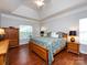 Spacious main bedroom showcases hardwood floors, a tray ceiling, and lots of natural light at 1423 Piper Ct, Concord, NC 28025