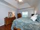 Large main bedroom featuring hardwood floors, tray ceiling, dresser and a queen bed at 1423 Piper Ct, Concord, NC 28025