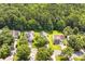 An aerial view shows houses with ample parking surrounded by lush green trees at 1515 Kingdom Way, Fort Mill, SC 29707