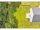 Aerial view of fenced-in backyard features a patio, fire pit, mature trees, and well-kept lawn at 1515 Kingdom Way, Fort Mill, SC 29707