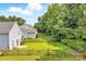 Expansive backyard features lush green lawn and wooden fence bordering wooded area at 1515 Kingdom Way, Fort Mill, SC 29707