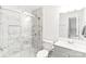 Modern bathroom featuring a glass shower, marble tile, and white fixtures and vanity at 1515 Kingdom Way, Fort Mill, SC 29707